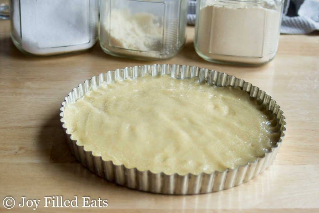 almond tart batter layered at bottom of pie tin
