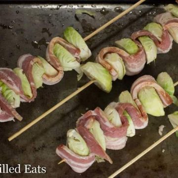 sheet pan lined with bacon & Brussels sprout kebabs before baking