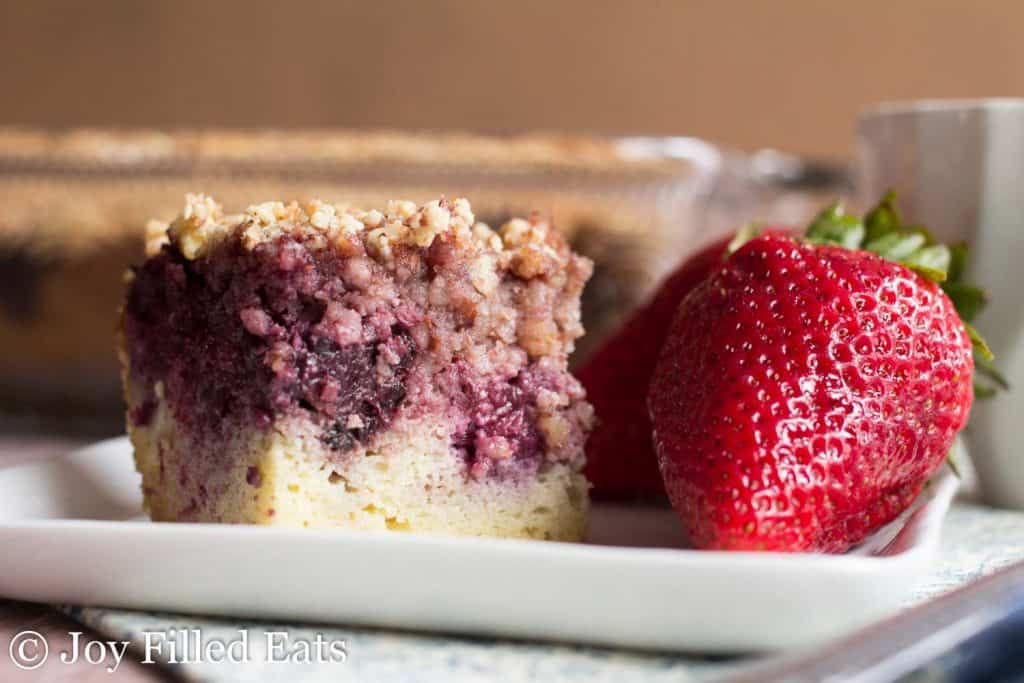 slice of blackberry coffee cake and whole strawberries