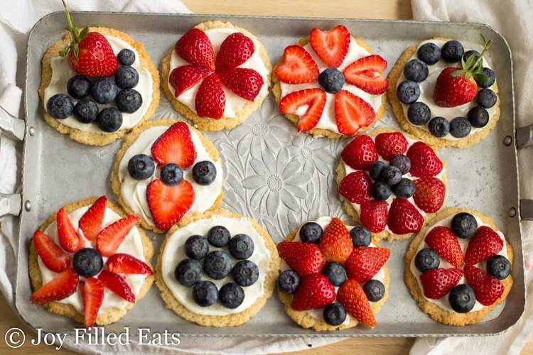 mixed mini fruit pizza cookies arranged on a tray