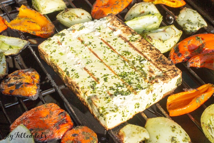 Grilling paneer cheese and veggies on a grill outside