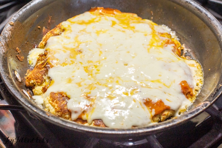 skillet pizza cooking and covered in melted cheese