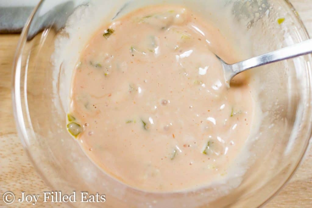 close up on homemade 1000 island dressing in a bowl with spoon