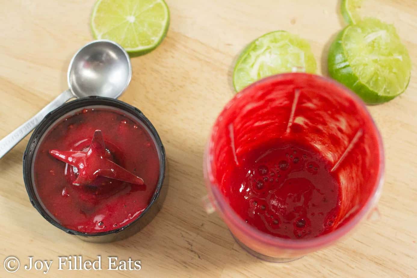 small blender filled with raspberry and lime puree for sparkling soda