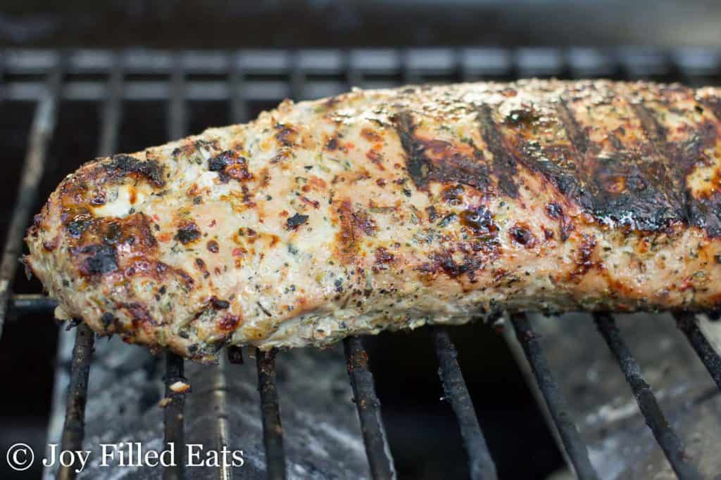 close up of pork tenderloin on a grill
