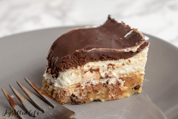 Cookie dough cheesecake with a layer of raw chocolate chip cookie dough, a layer of creamy cheesecake, and a layer of rich chocolate ganache.