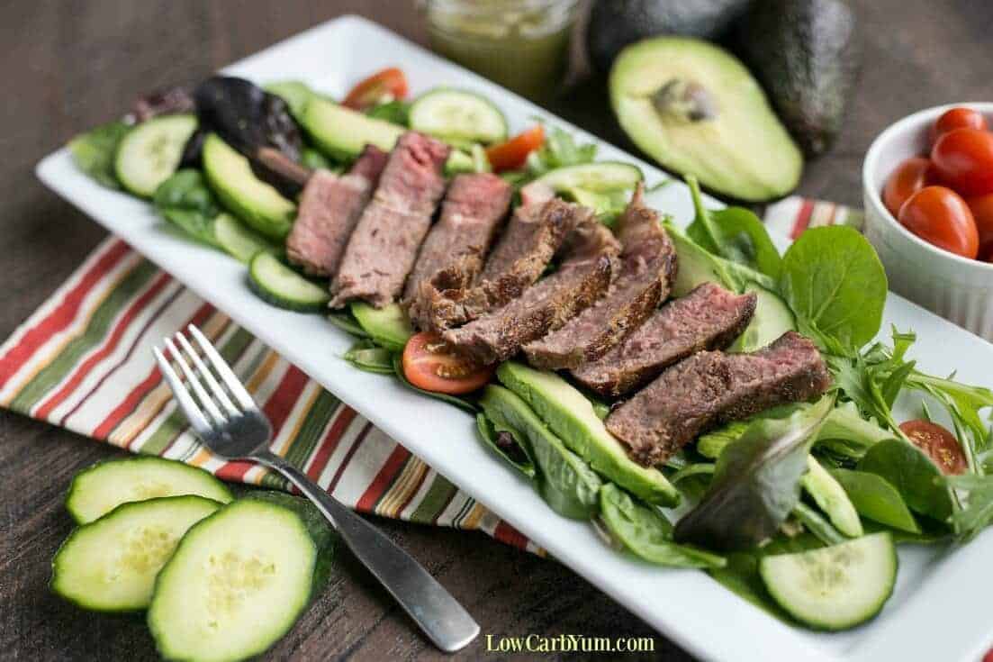 southwest steak salad with spicy avocado dressing on a long white platter
