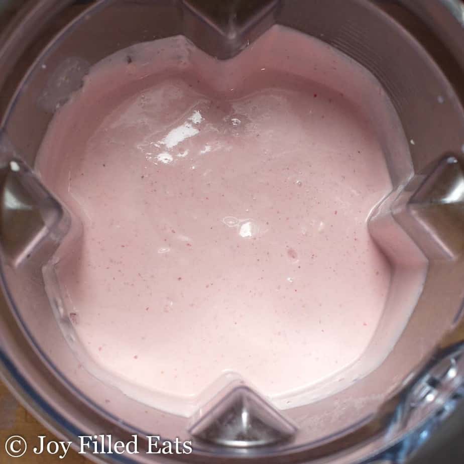 Strawberry Ricotta Ice Cream mixture inside an ice cream maker