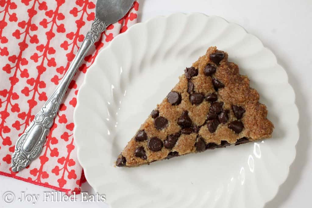 overhead view of chocolate chip cookie tart slice on a white plate