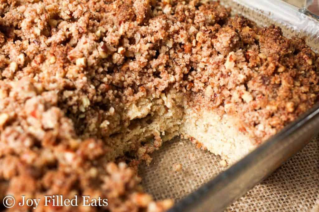 cinnamon pecan crumb cake in a baking dish with slice removed