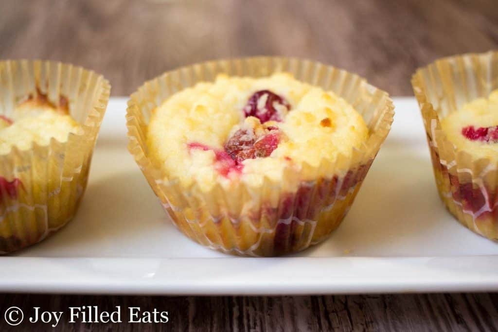Cranberry Orange Muffins lined on a white platter