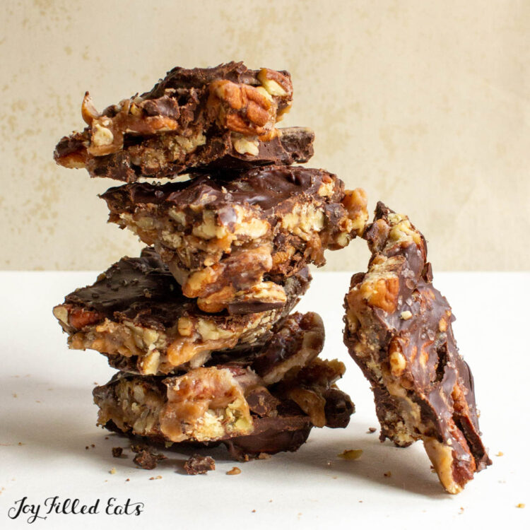 keto christmas crack toffee in a stack with a piece leaning on its side