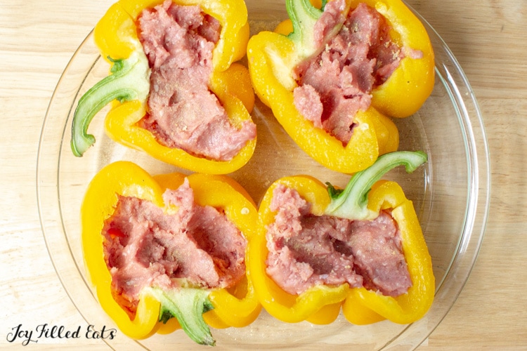 Halved yellow peppers stuffed with ground turkey