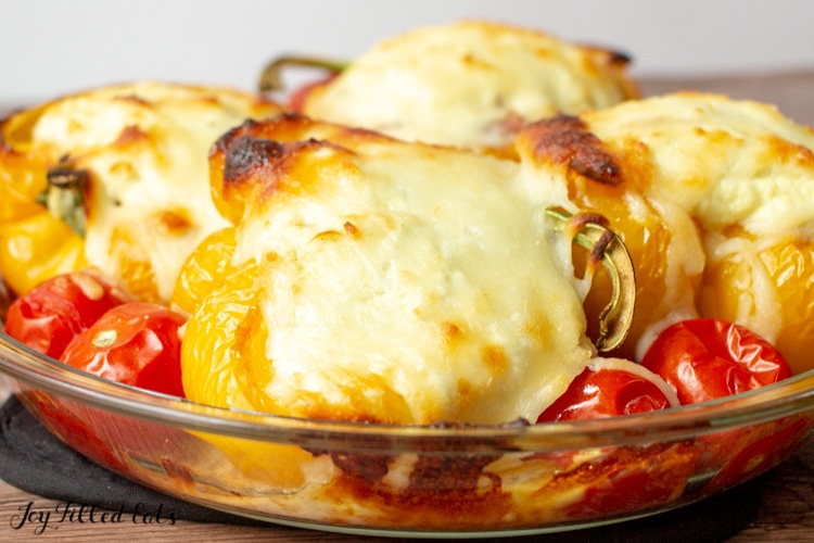 close up of the keto stuffed peppers with golden mozzarella cheese in a glass pie plate