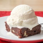 brownie topped with keto vanilla ice cream on a plate