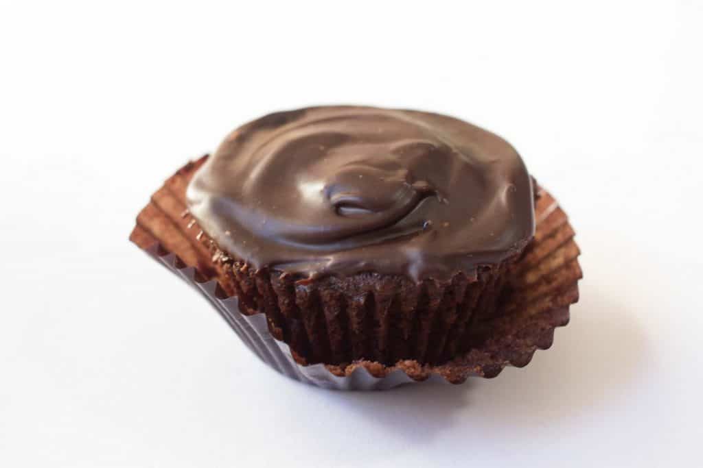 close up on a dark chocolate peppermint cupcake with the wrapper slightly removed