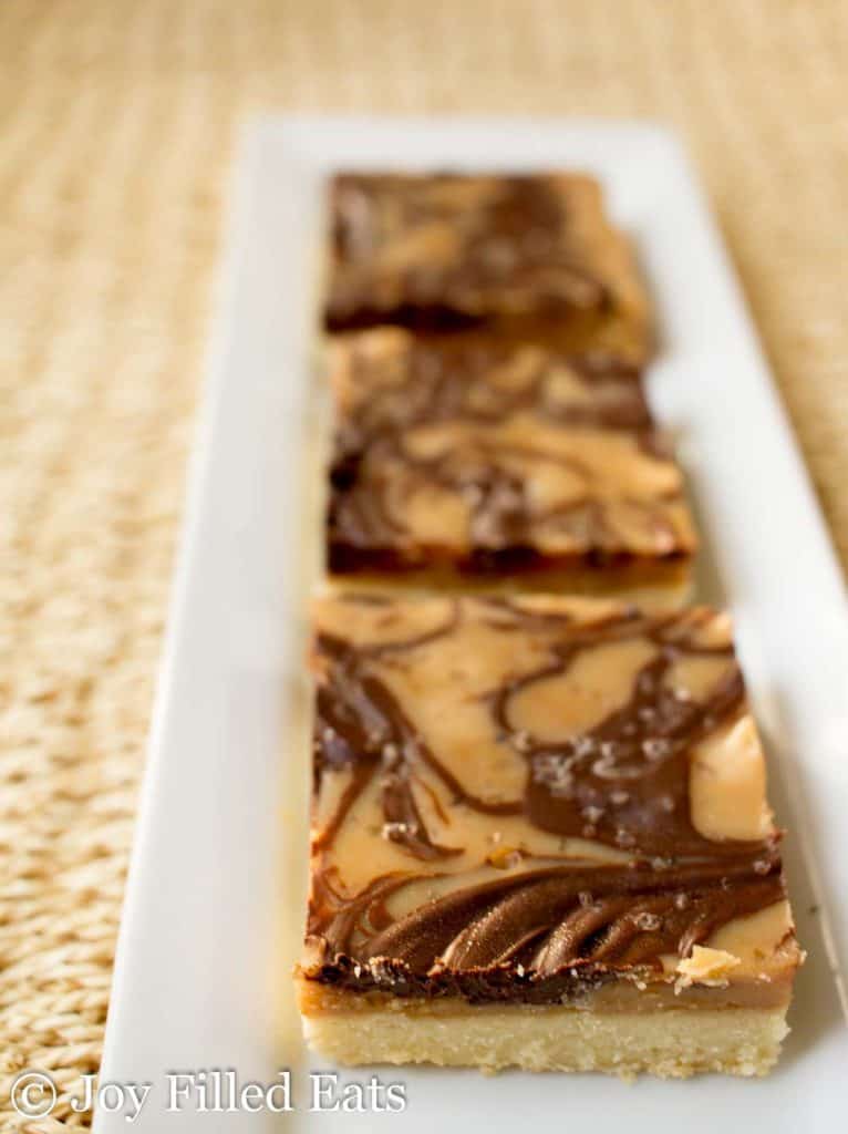 salted caramel shortbread squares lined on a platter close up