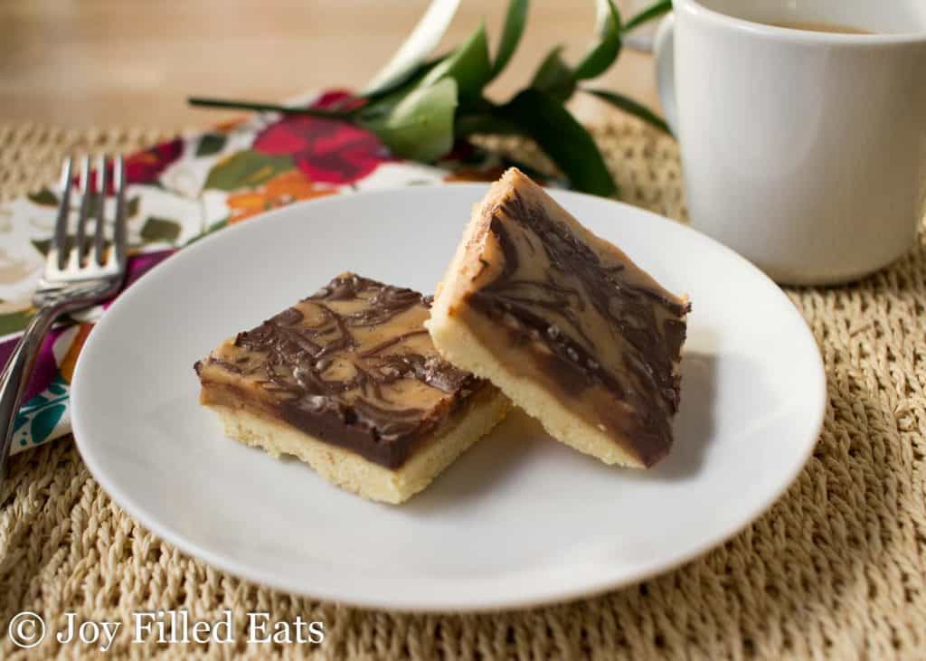 two salted caramel shortbread squares on a white plate