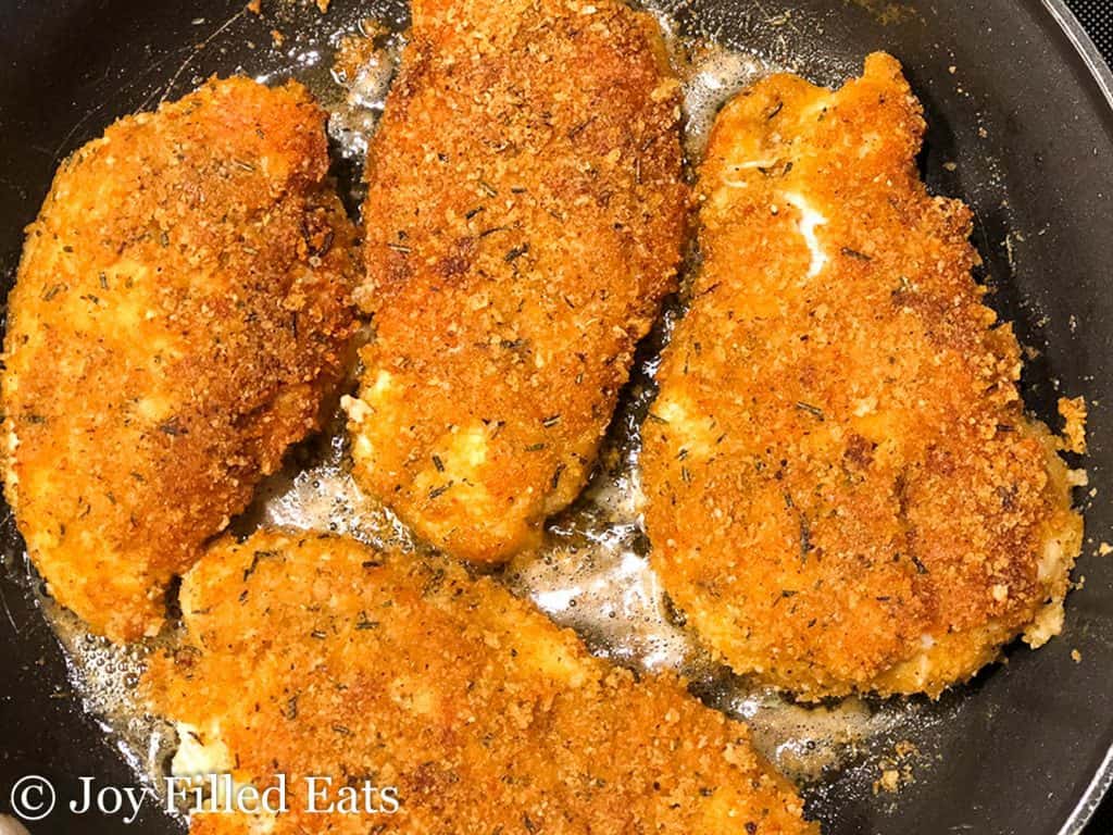 Southern Style Breaded Chicken Breast cooking in a skillet