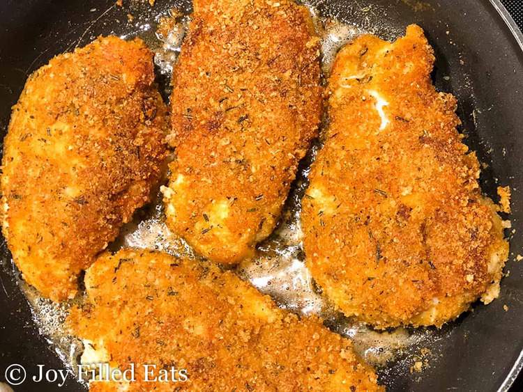 Southern Style Breaded Chicken Breast cooking in a skillet
