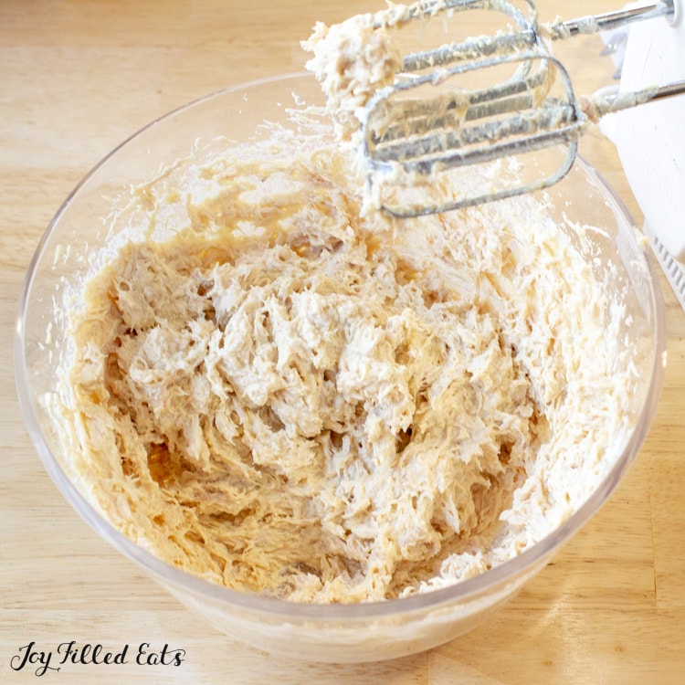 bowl of low carb chicken nugget mixture with a hand mixer