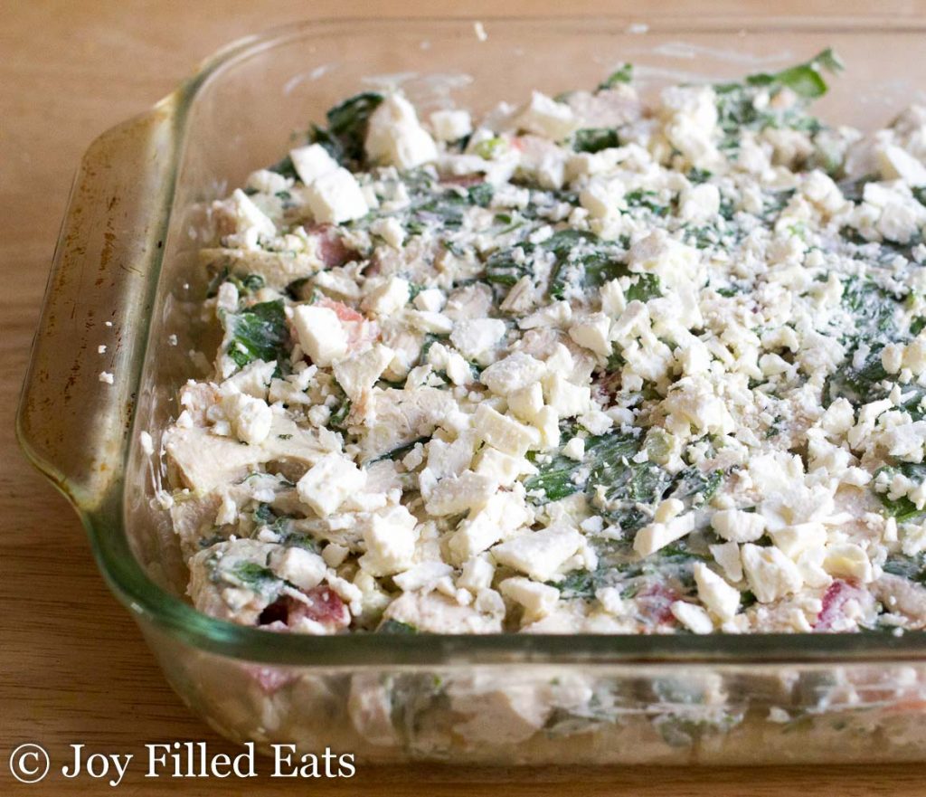 Mediterranean Chicken & Spinach Casserole topped with Feta cheese up close