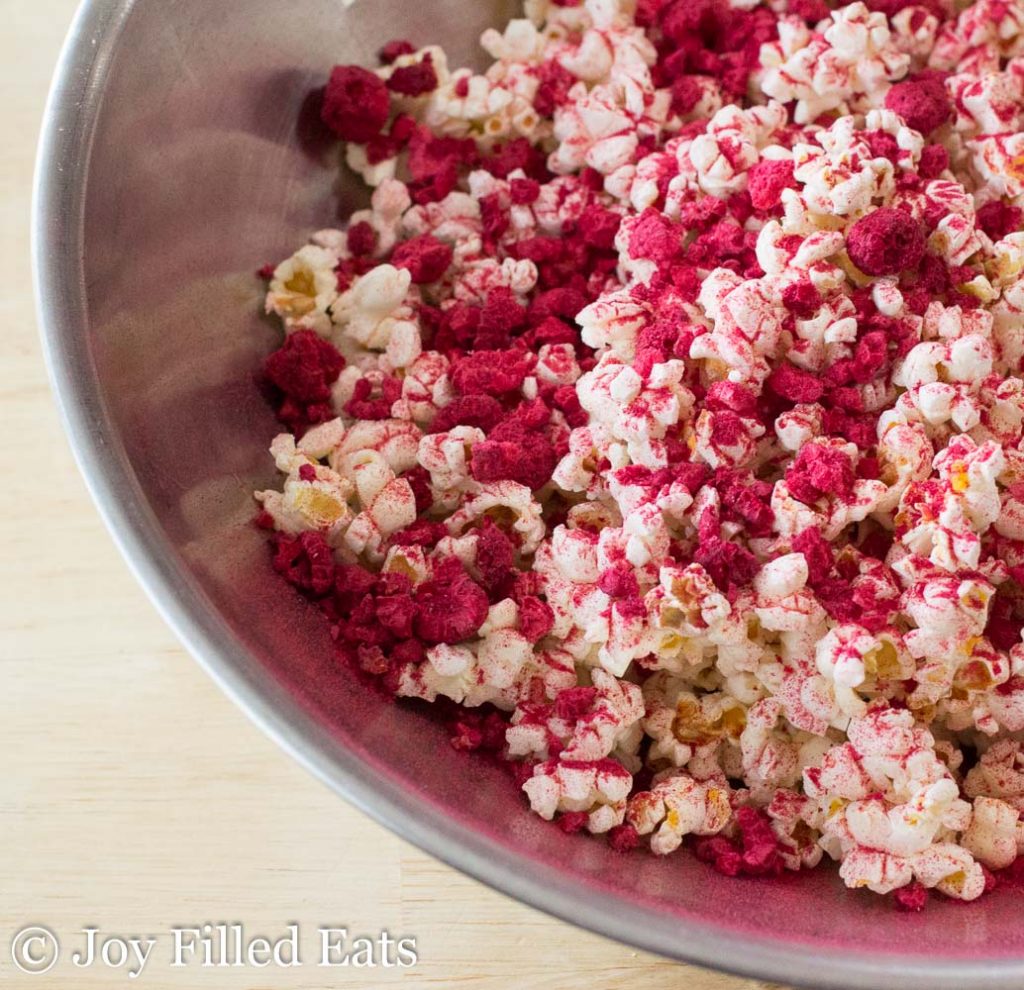 close up on raspberry lemonade popcorn in the large bowl