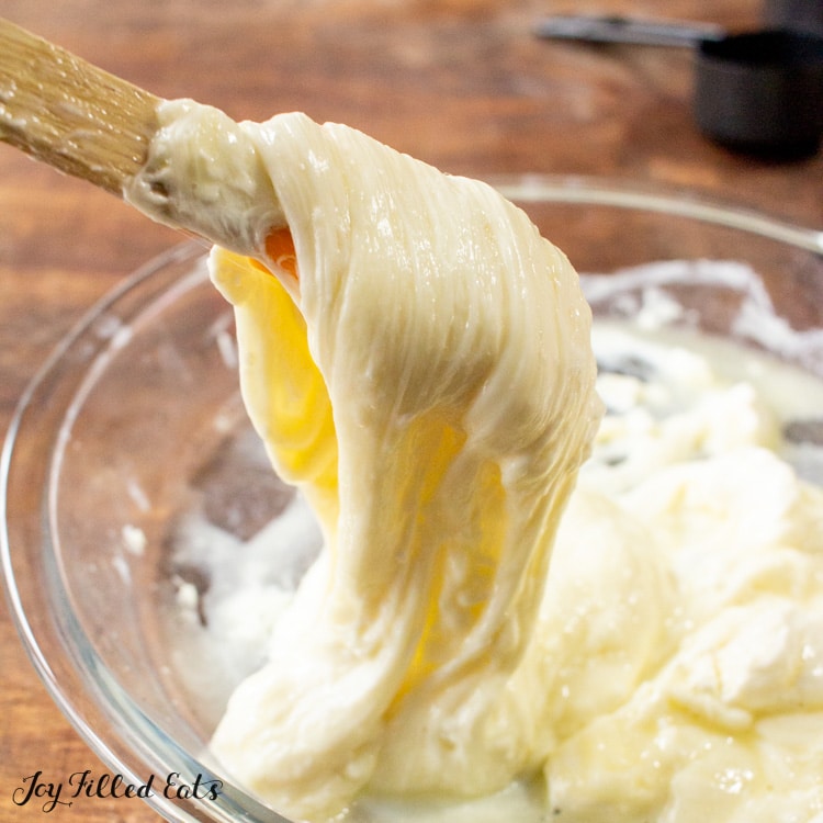 dough being mixed with wooden spoon