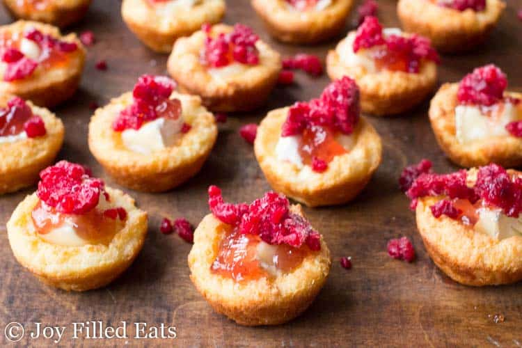 Raspberry Appetizer Brie Bites lined on a table surface