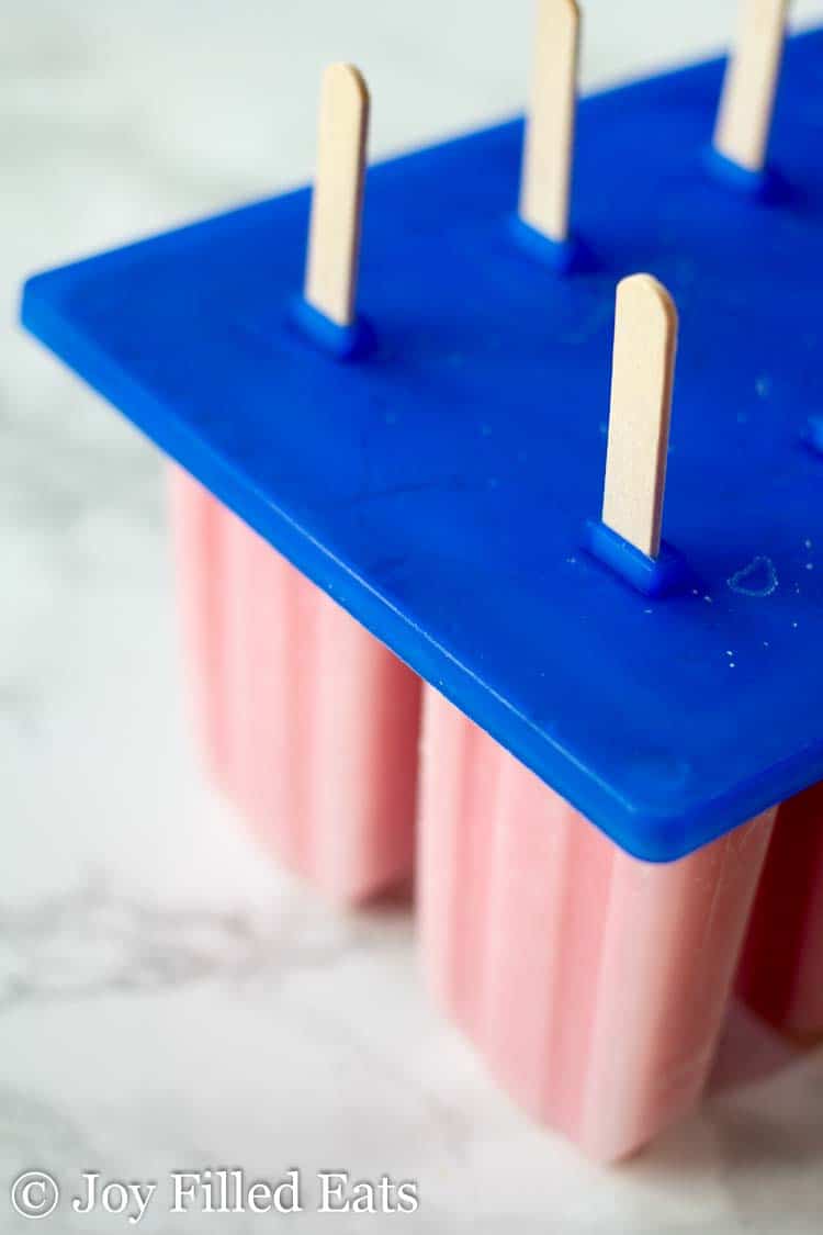 Popsicle mold with Strawberry Popsicles inside