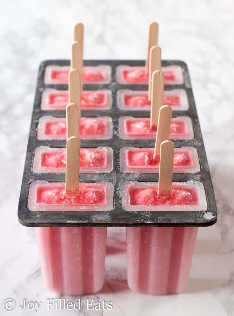 ice pop mold filled with strawberry popsicles