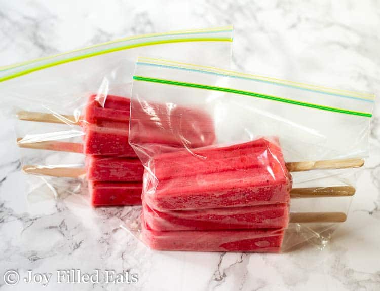 plastic bags filled with stacks of strawberry popsicles