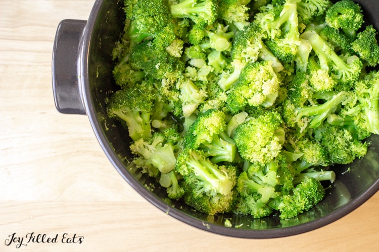 Steamed broccoli in a large black pot