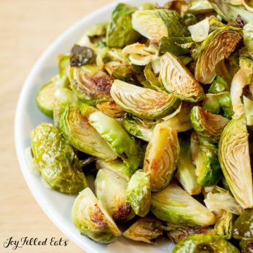 close up of the Roasted Brussels Sprouts with Garlic in a white bowl