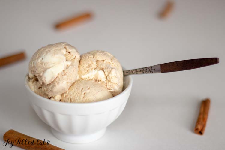 Cinnamon Roll Ice Cream with a Cream Cheese Icing Swirl in a white bowl with a spoon