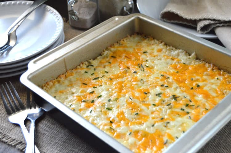 Green Chile Keto Cauliflower Casserole in a square metal baking dish