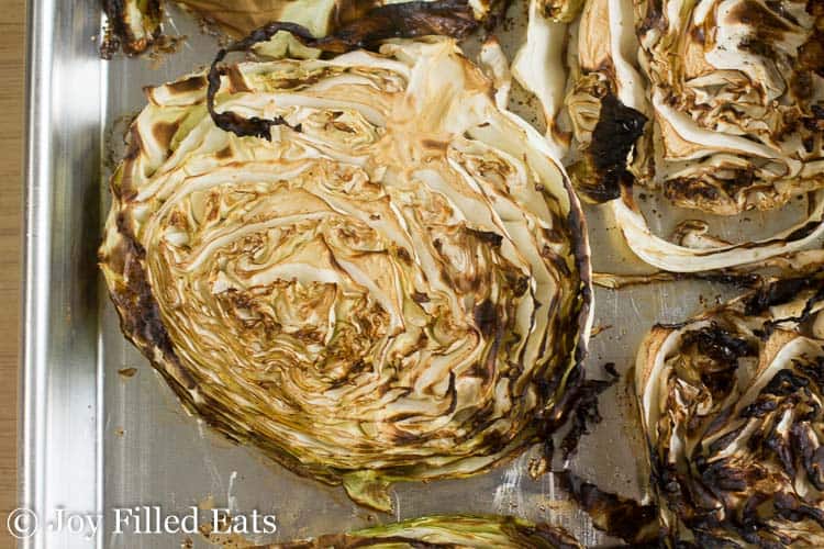 close up on roasted cabbage steak with balsamic on sheet pan