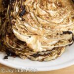 close up on roasted cabbage steaks with balsamic