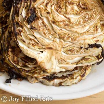close up on roasted cabbage steaks with balsamic