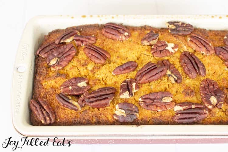 low carb pumpkin bread topped with pecans in a bread pan