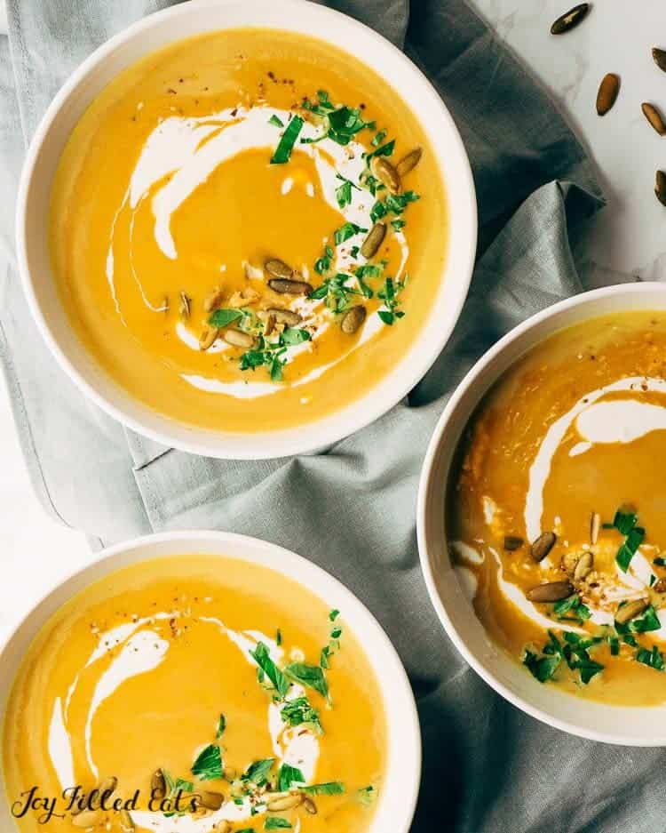 three bowls of pumpkin soup from above