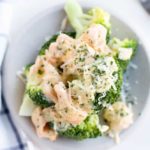 close up on plate of cheesy smoked salmon with broccoli