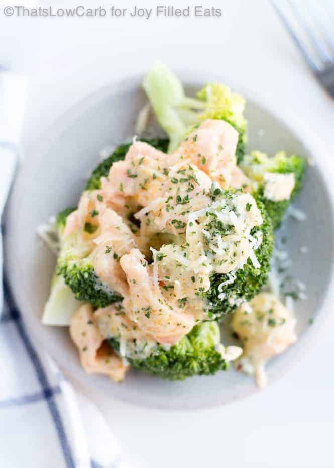 close up on plate of cheesy smoked salmon with broccoli