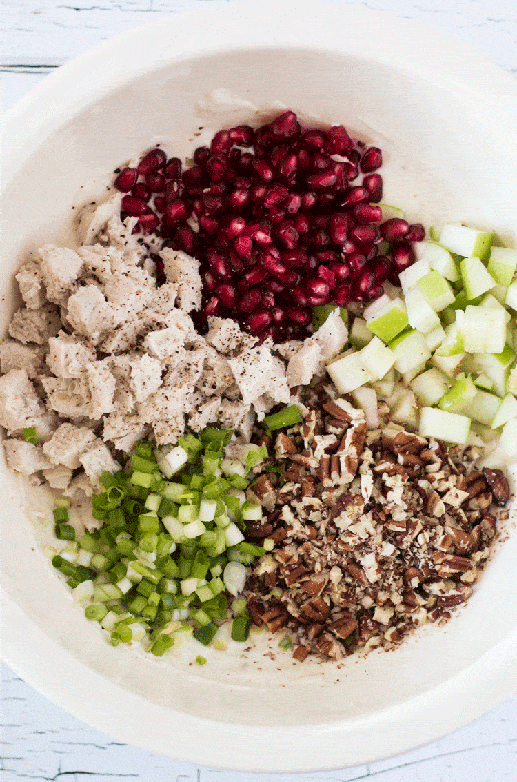 ingredients for pomegranate chicken salad cucumber bites in a mixing bowl before being combined