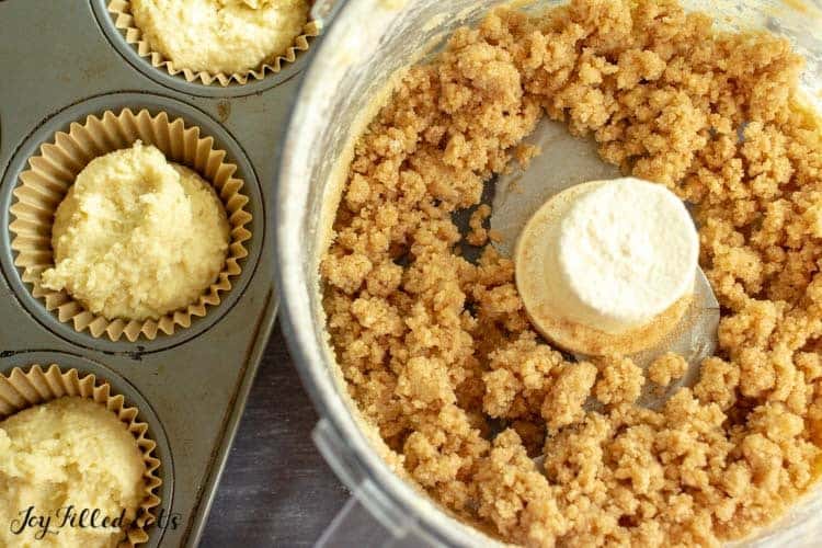 coffee cake crumb topping in food processor next to muffin tin filled with coffee cake batter