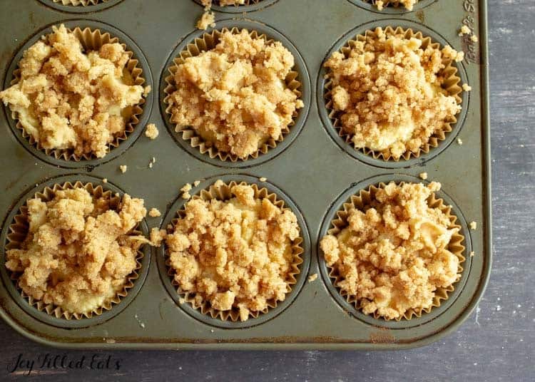 overhead view of muffin tin with coffee cake muffins