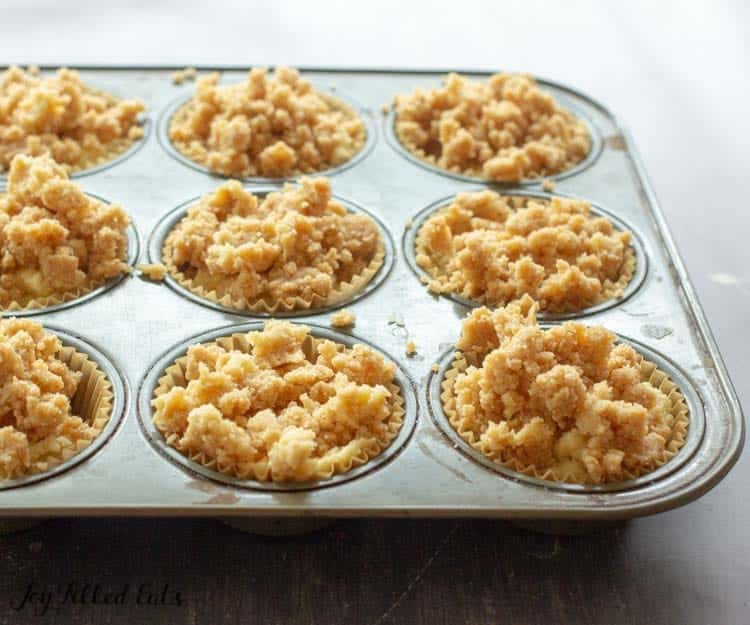 coffee cake muffins topped with crumb topping in muffin tin