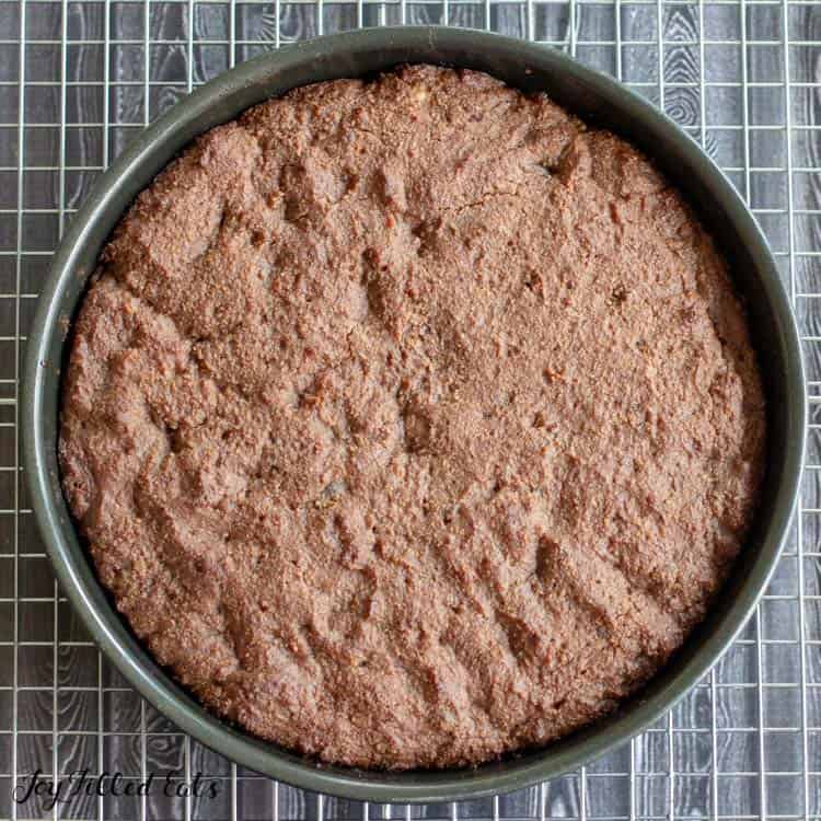 overhead view of keto marble chocolate cake batter pressed into round baking tin