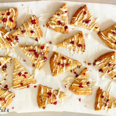 lemon drizzle cranberry cookies arranged on parchment paper from above