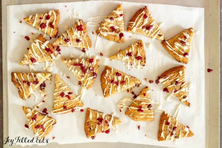 lemon drizzle cranberry cookies arranged on parchment paper from above